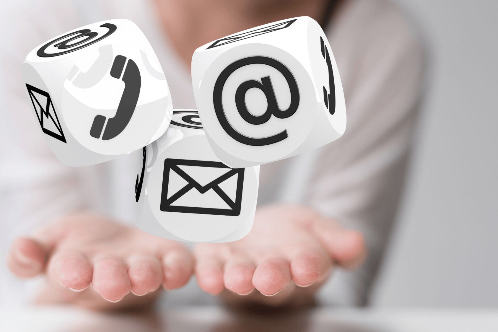 contact us slide featuring a pair of woman hands cupping three white dice with an email, telephone and mail icon on each one